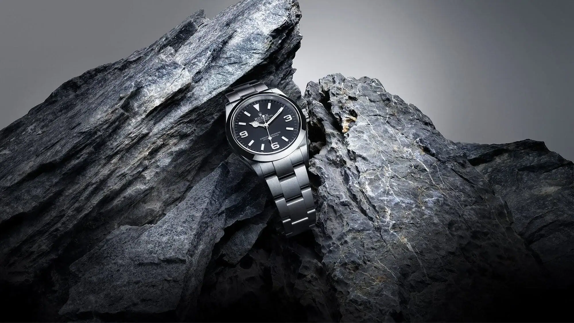Rolex Explorer watch with black dial set among rocks - Lucerne Watches 
